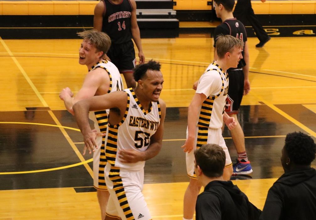 Sophomore Karl Drammeh (center) celebrates with sophomores David H&ouml;&ouml;k (left) and Jonatan Arvidsson (right) near the end of EWC's 90-68 win against Northwest Saturday.