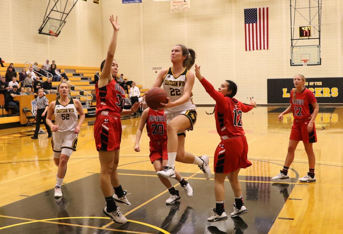 EWC freshman Ane Esnal Aguirre attempts a lay up in the midst of three Northwest Trapper defenders during the Lancers' Region IX-North win Saturday afternoon in Torrington.